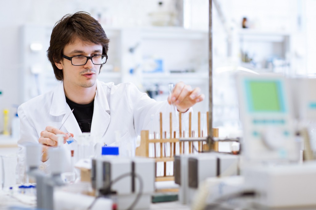 young, male researcher/chemistry student carrying out scientific